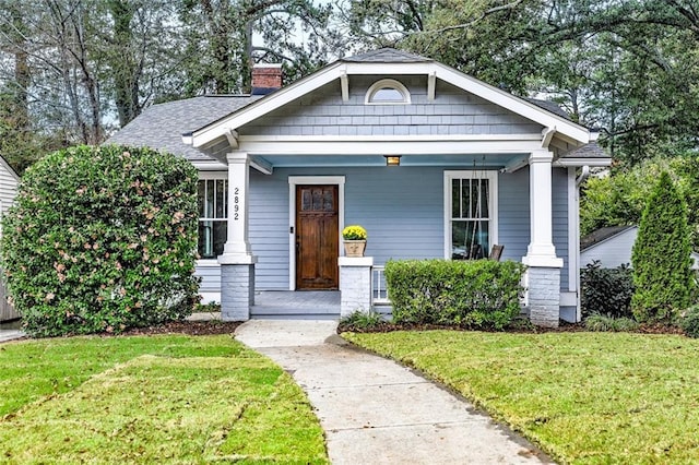 view of front of property with a front lawn and a porch