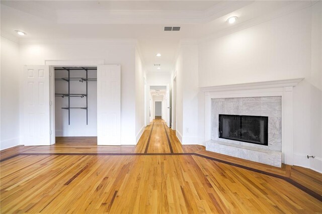 unfurnished living room with crown molding and wood-type flooring