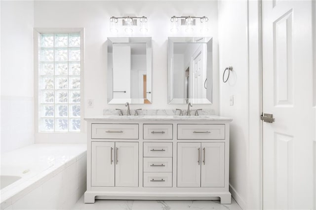 bathroom featuring vanity and a relaxing tiled tub