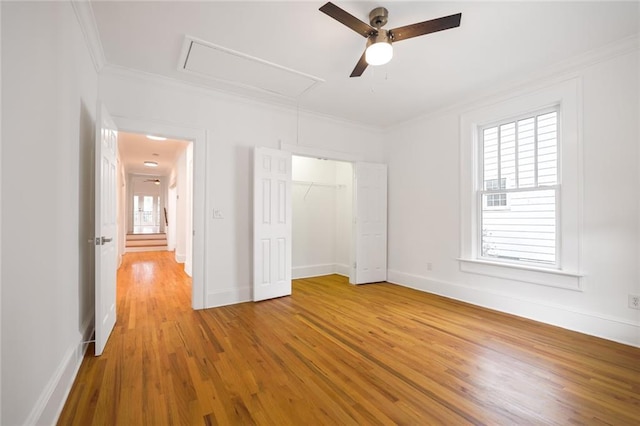 unfurnished bedroom with hardwood / wood-style flooring, ceiling fan, a closet, and multiple windows