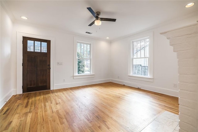 entrance foyer featuring light hardwood / wood-style floors, crown molding, ceiling fan, and a healthy amount of sunlight