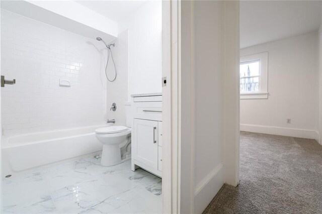 bathroom featuring tiled shower / bath combo and toilet