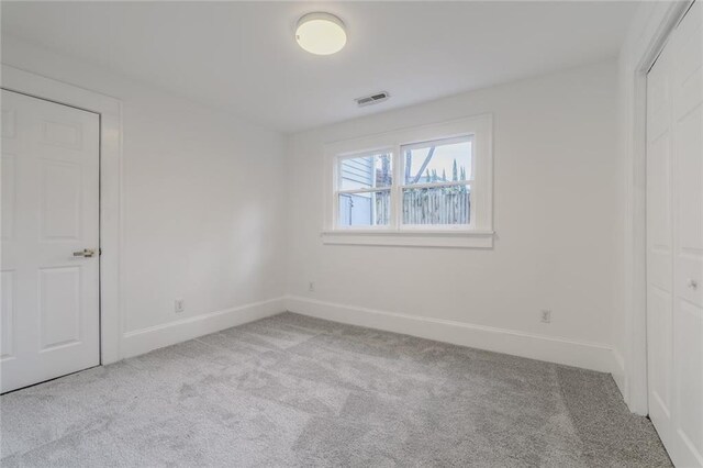 unfurnished bedroom featuring light colored carpet