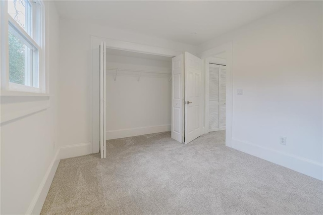 unfurnished bedroom featuring light colored carpet