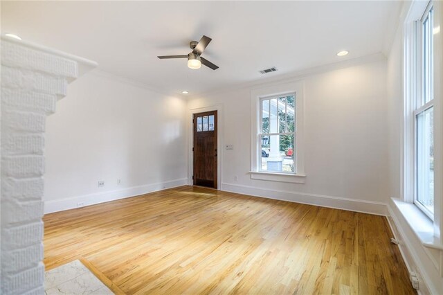 interior space featuring ceiling fan, hardwood / wood-style floors, and ornamental molding