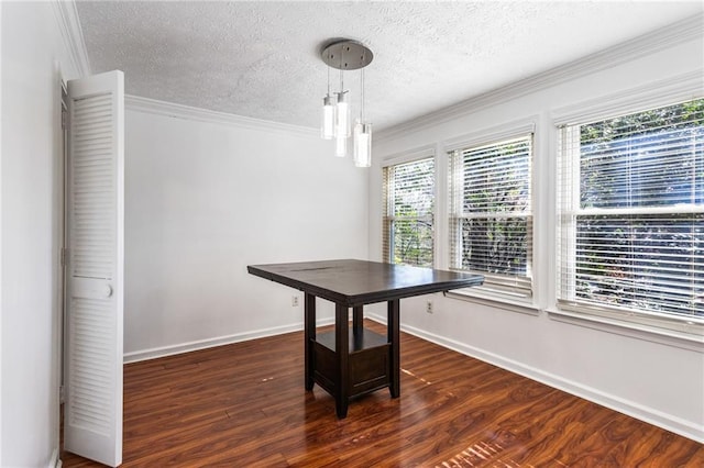 dining room featuring dark wood finished floors, a textured ceiling, baseboards, and ornamental molding