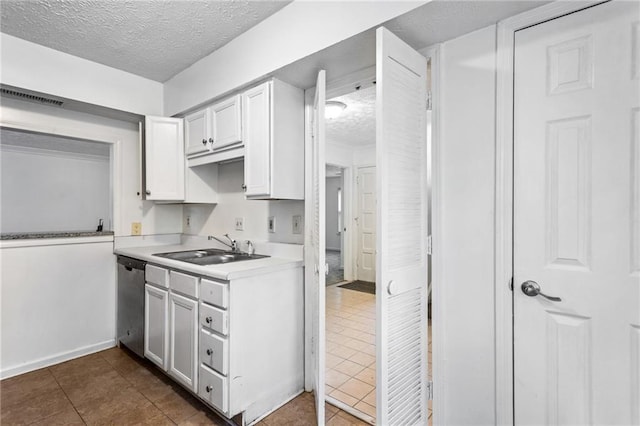 kitchen with visible vents, dishwasher, a textured ceiling, and a sink