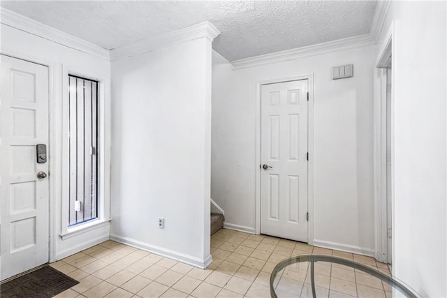 entrance foyer with a textured ceiling, stairway, light tile patterned flooring, and ornamental molding