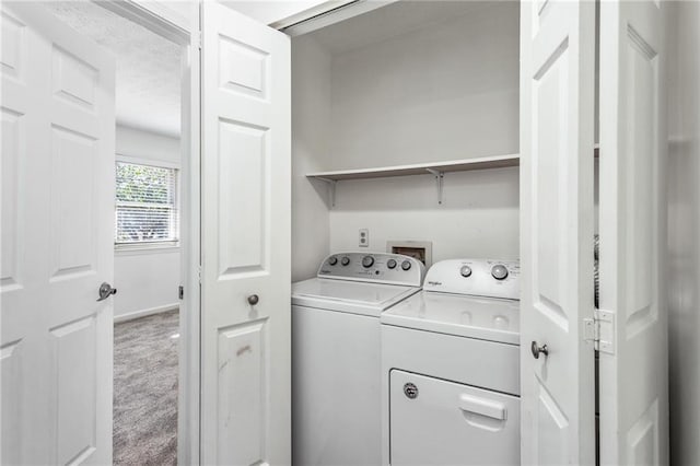 laundry area with carpet, laundry area, washing machine and dryer, and a textured ceiling