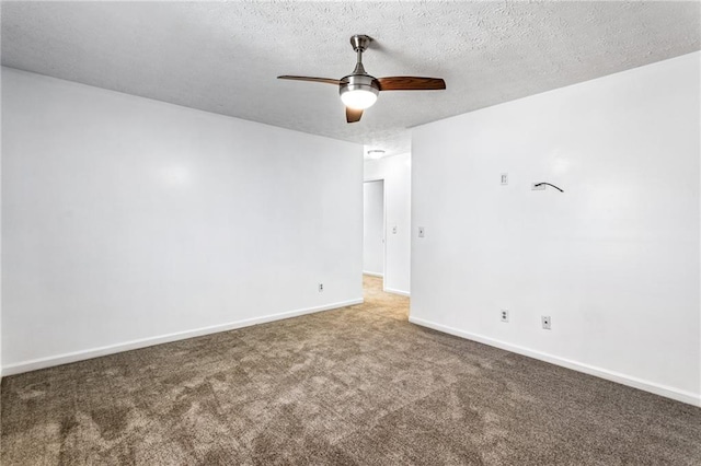 spare room featuring carpet flooring, baseboards, a textured ceiling, and a ceiling fan