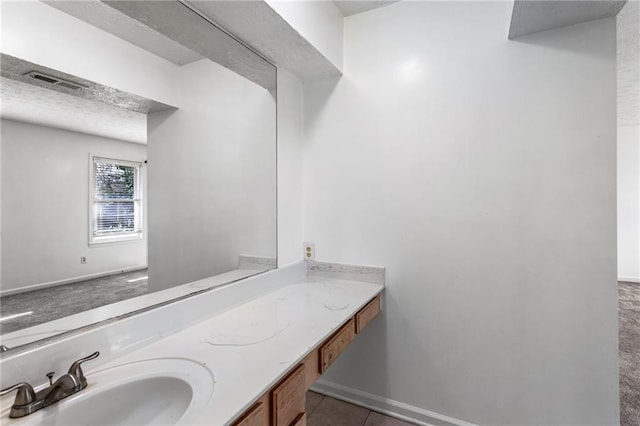 bathroom with vanity, tile patterned floors, baseboards, and visible vents