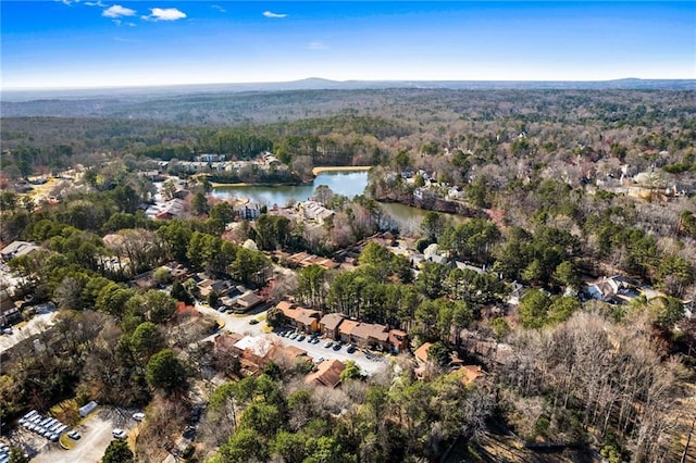 aerial view featuring a forest view and a water view