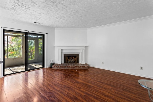 unfurnished living room with visible vents, a textured ceiling, wood finished floors, crown molding, and baseboards