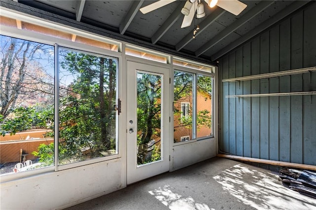 unfurnished sunroom featuring lofted ceiling and a ceiling fan