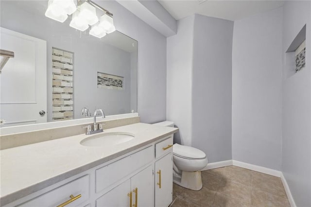 bathroom featuring tile patterned flooring, vanity, and toilet