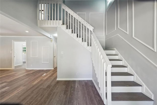 stairway featuring hardwood / wood-style floors and crown molding