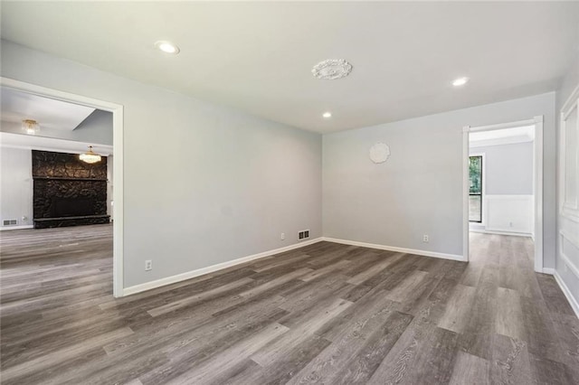 empty room featuring a fireplace and dark wood-type flooring