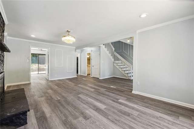 unfurnished living room with a fireplace, ornamental molding, and hardwood / wood-style flooring