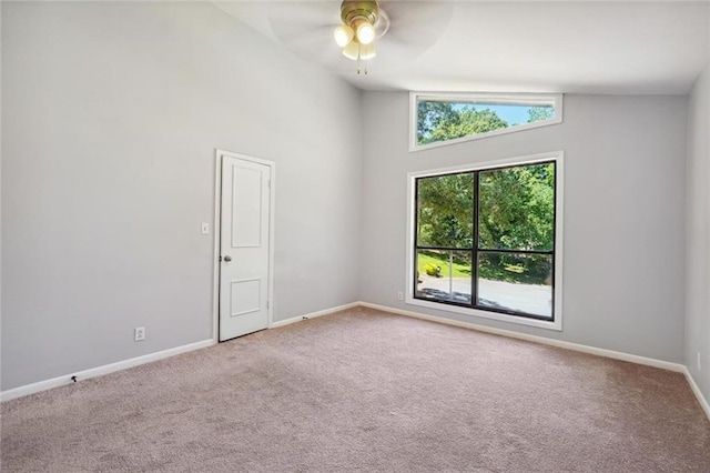 unfurnished room featuring carpet, high vaulted ceiling, and ceiling fan