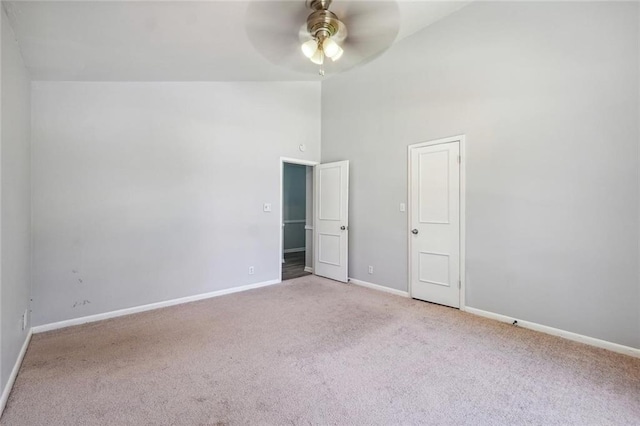 unfurnished bedroom with ceiling fan, high vaulted ceiling, and light carpet