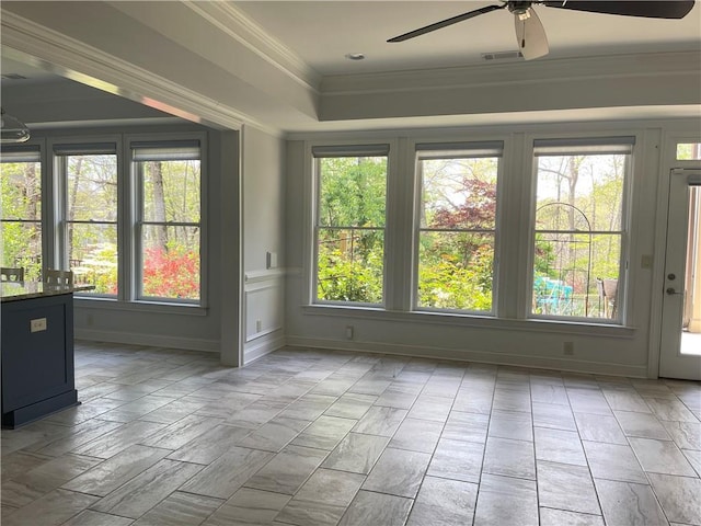 unfurnished room featuring plenty of natural light, a ceiling fan, and ornamental molding