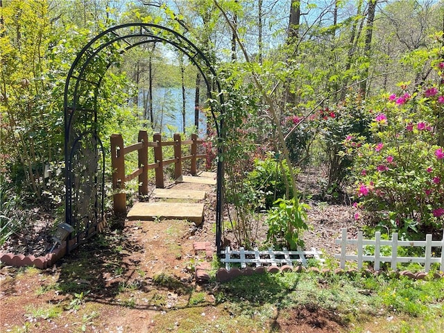 view of yard featuring fence and a water view