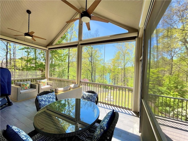 sunroom / solarium with an outdoor hangout area, beam ceiling, and ceiling fan
