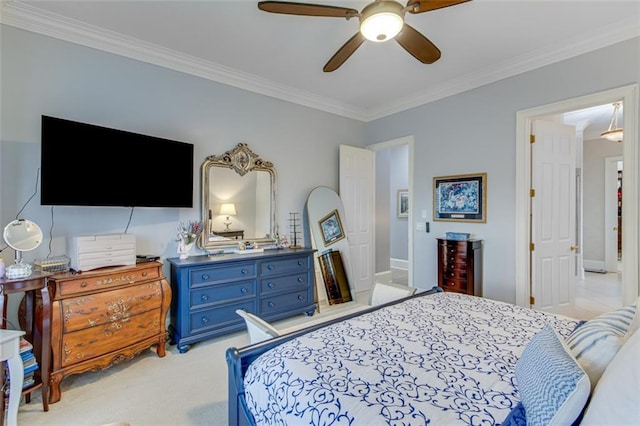bedroom featuring baseboards, a ceiling fan, light colored carpet, and ornamental molding