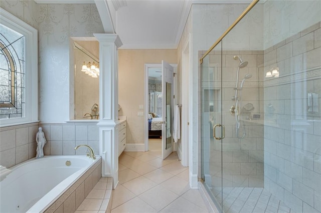 ensuite bathroom featuring connected bathroom, a shower stall, crown molding, and ornate columns
