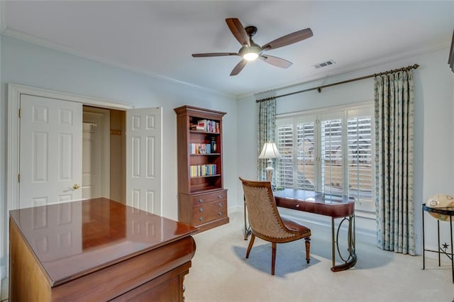 home office featuring ceiling fan, light colored carpet, baseboards, ornamental molding, and visible vents