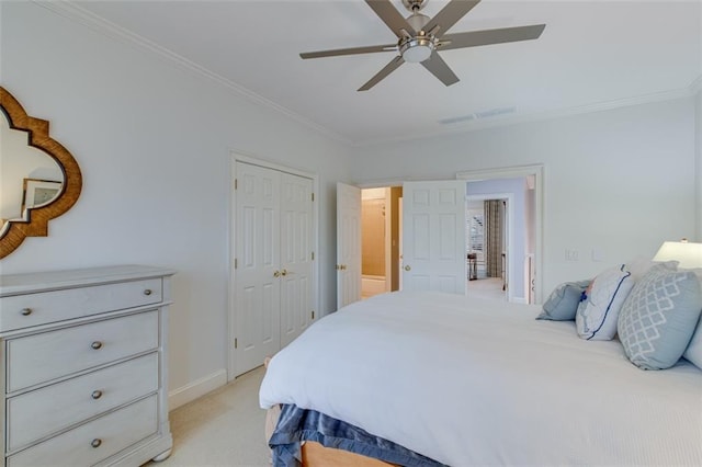bedroom with a closet, light colored carpet, baseboards, ornamental molding, and visible vents
