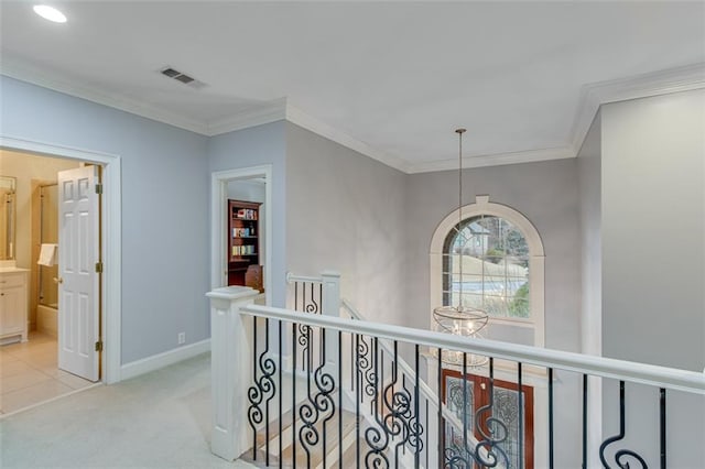 hall featuring visible vents, light carpet, an upstairs landing, crown molding, and baseboards