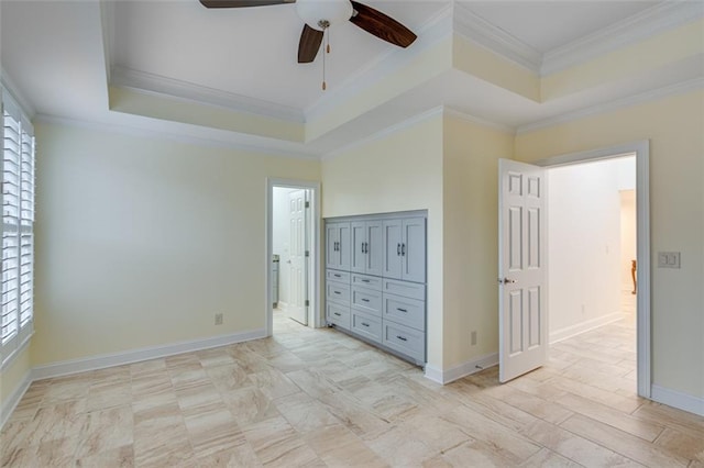 unfurnished bedroom with baseboards, ornamental molding, a raised ceiling, and ceiling fan