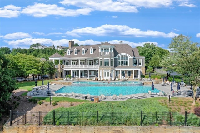 view of swimming pool with a lawn, fence, a patio, and a fenced in pool