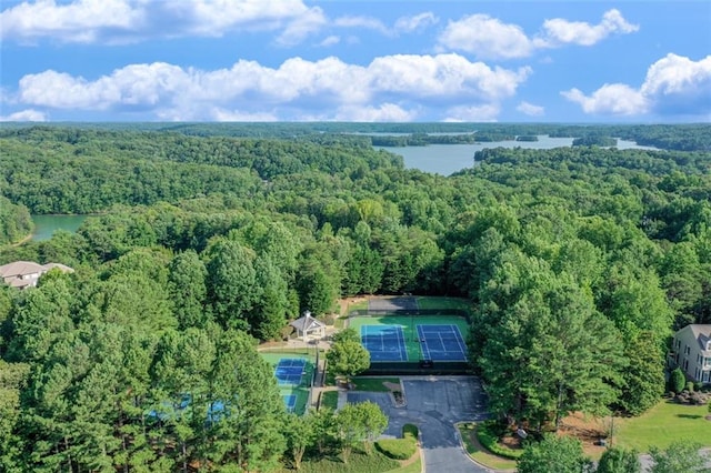 drone / aerial view featuring a forest view and a water view