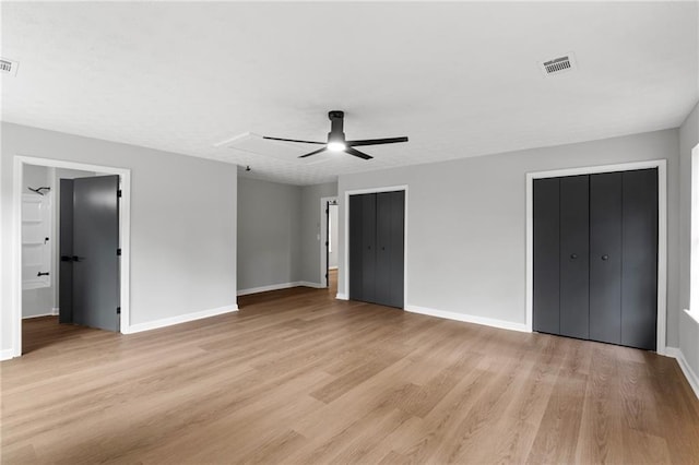 40 Melton Way, Covington, GA 30016 - unfurnished bedroom featuring light wood finished floors, multiple closets, a ceiling fan, and ensuite bathroom