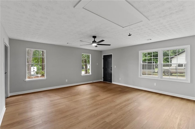 40 Melton Way, Covington, GA 30016 - spare room with attic access, light wood-style flooring, a textured ceiling, plenty of natural light, and ceiling fan
