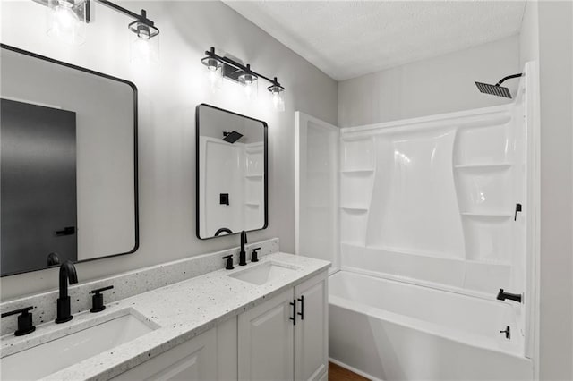 40 Melton Way, Covington, GA 30016 - full bath with double vanity, shower / washtub combination, and a textured ceiling