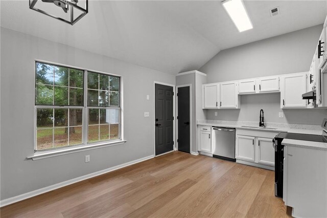 40 Melton Way, Covington, GA 30016 - kitchen with stainless steel dishwasher, range with electric stovetop, lofted ceiling, light wood-style flooring, and light countertops