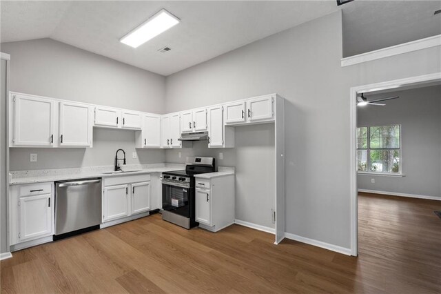 40 Melton Way, Covington, GA 30016 - kitchen featuring stainless steel appliances, under cabinet range hood, high vaulted ceiling, wood finished floors, and white cabinetry