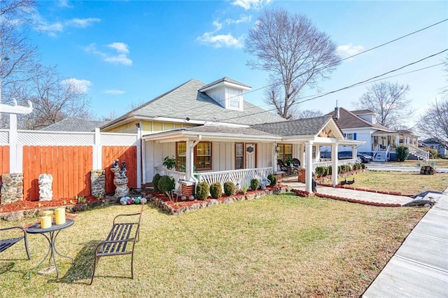 view of front of house featuring a front lawn and covered porch