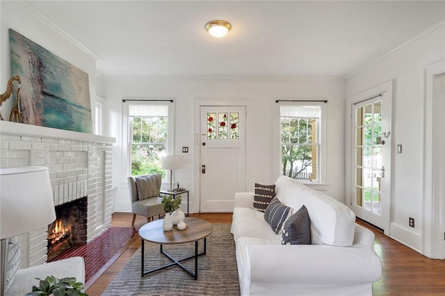 636 Cameron St SE, Atlanta, GA 30312 - living room featuring wood finished floors, a brick fireplace, and crown molding