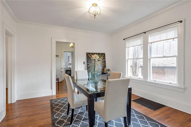 636 Cameron St SE, Atlanta, GA 30312 - dining space featuring dark wood-style floors, baseboards, ornamental molding, and a chandelier
