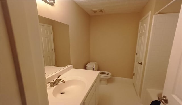 bathroom featuring vanity, a textured ceiling, and toilet