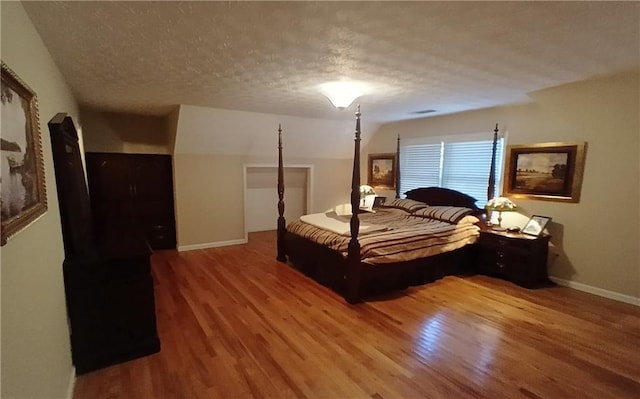 bedroom featuring wood-type flooring and a textured ceiling