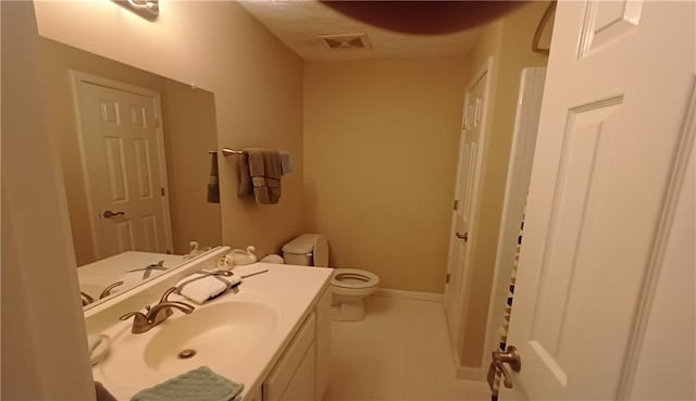 bathroom featuring toilet and vanity