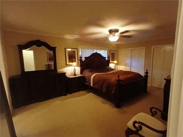 bedroom with carpet, ceiling fan, and crown molding