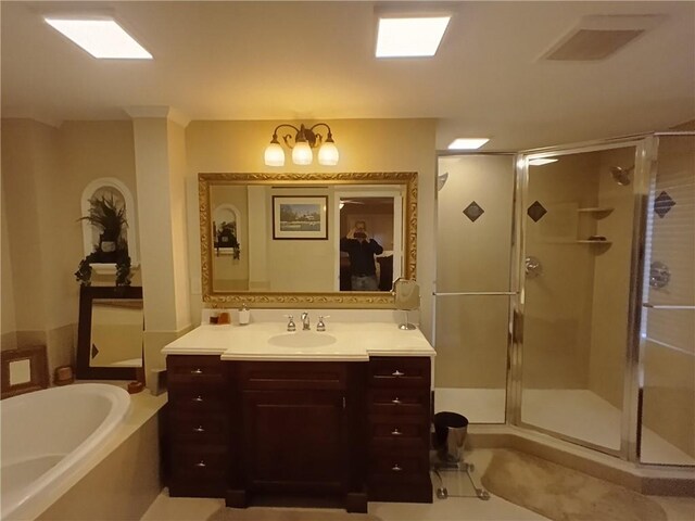 bathroom with vanity and separate shower and tub