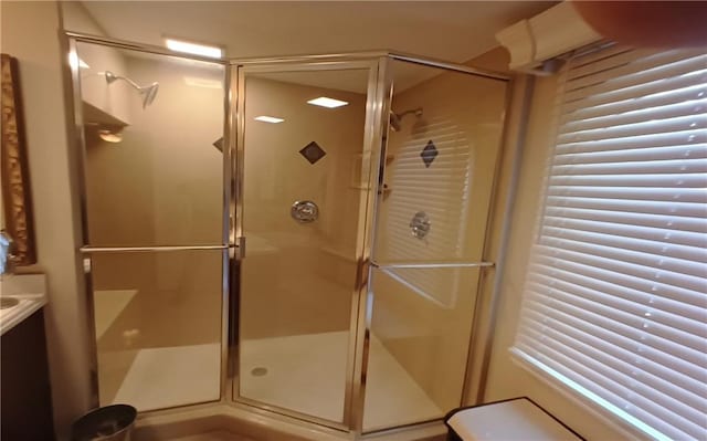 bathroom with an enclosed shower and vanity