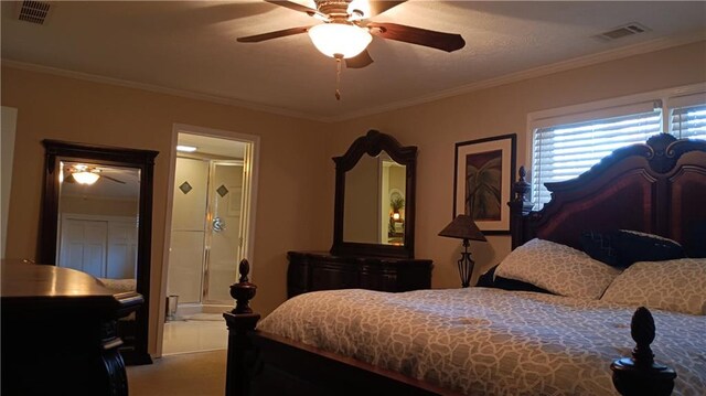 bedroom with ornamental molding, ceiling fan, and ensuite bath